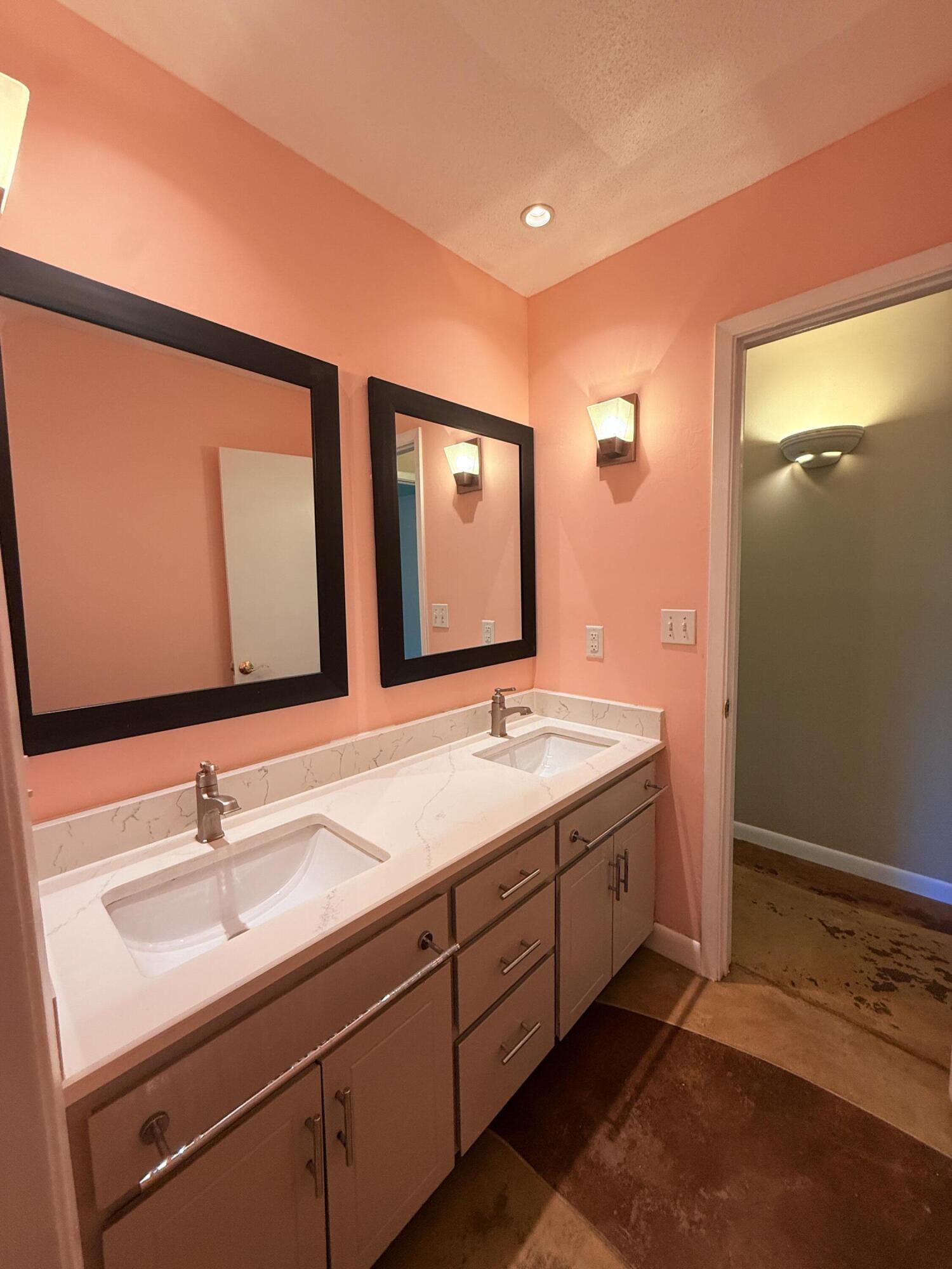 255 Ridge Lake Road Crestview, FL 32536 - Photo 19 of 39 a bathroom with a double vanity sink and a mirror