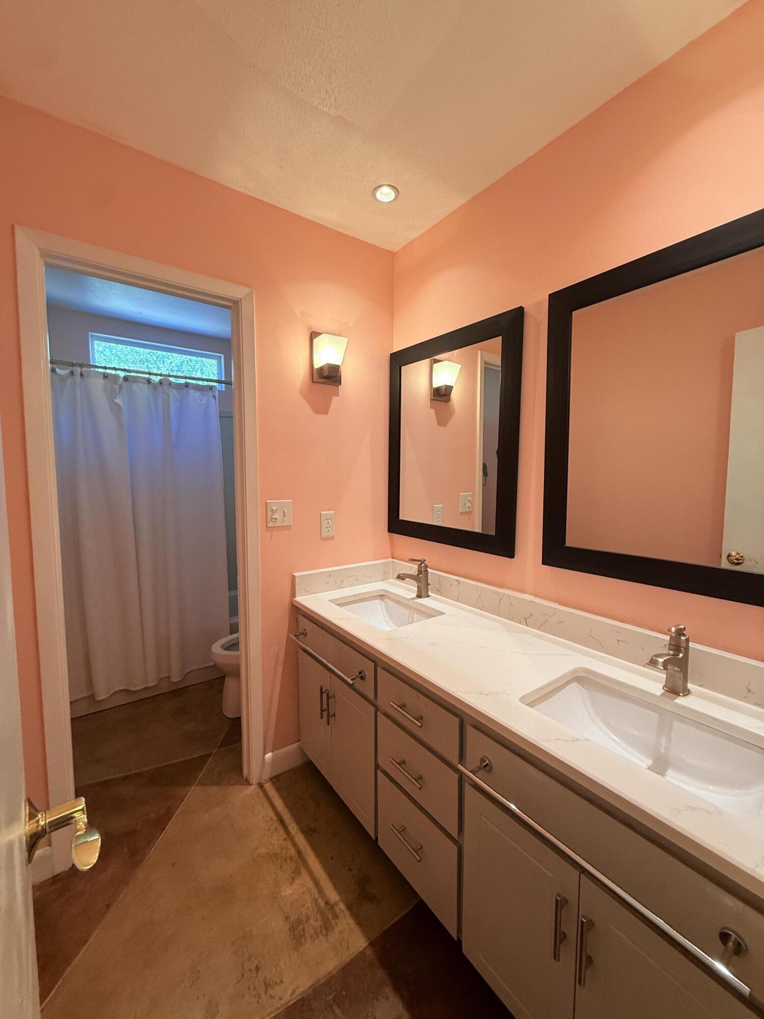 255 Ridge Lake Road Crestview, FL 32536 - Photo 20 of 39 a bathroom with a double vanity sink and a mirror