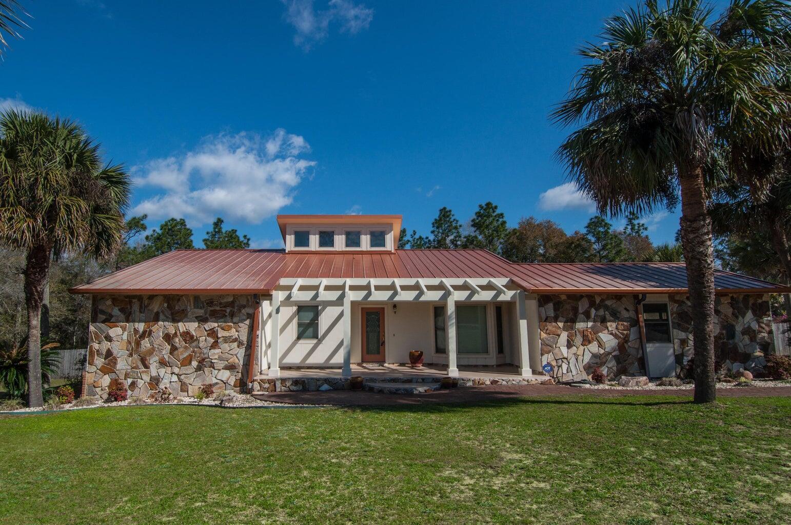 255 Ridge Lake Road Crestview, FL 32536 - Photo 2 of 39 a front view of a house with garden