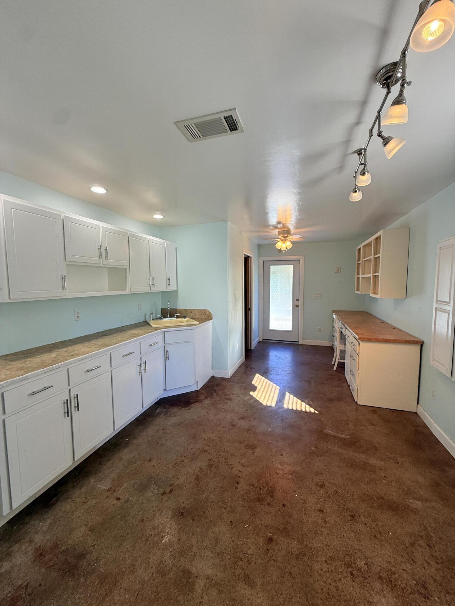 255 Ridge Lake Road Crestview, FL 32536 - Photo 29 of 39 a large kitchen with lot of cabinets and wooden floor