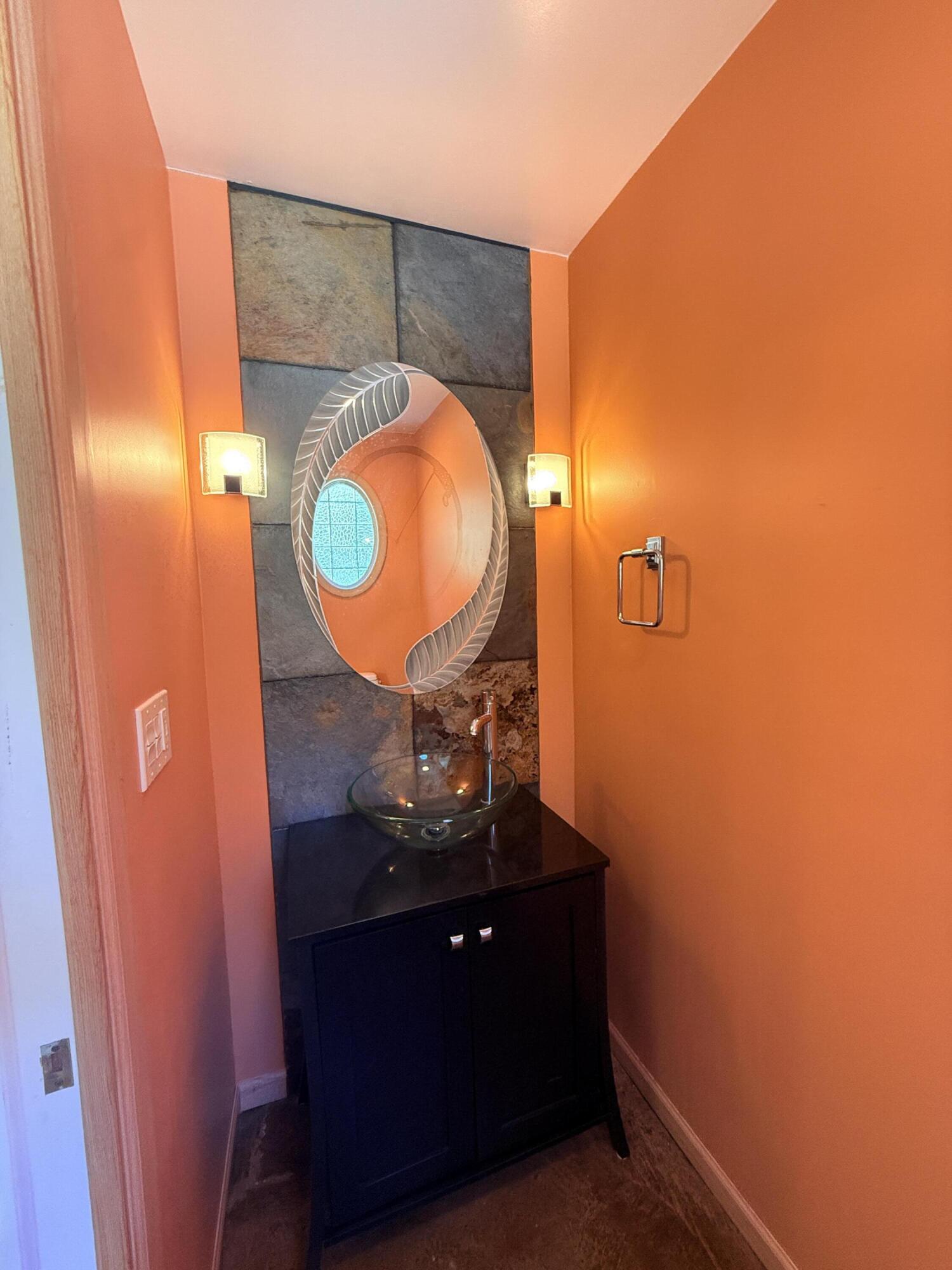 255 Ridge Lake Road Crestview, FL 32536 - Photo 30 of 39 a room with a mirror and vanity