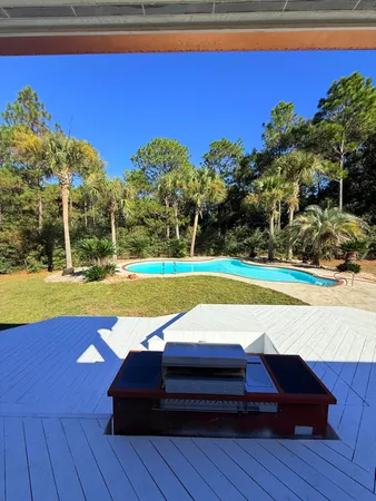a living room with couches chairs and wooden floor
