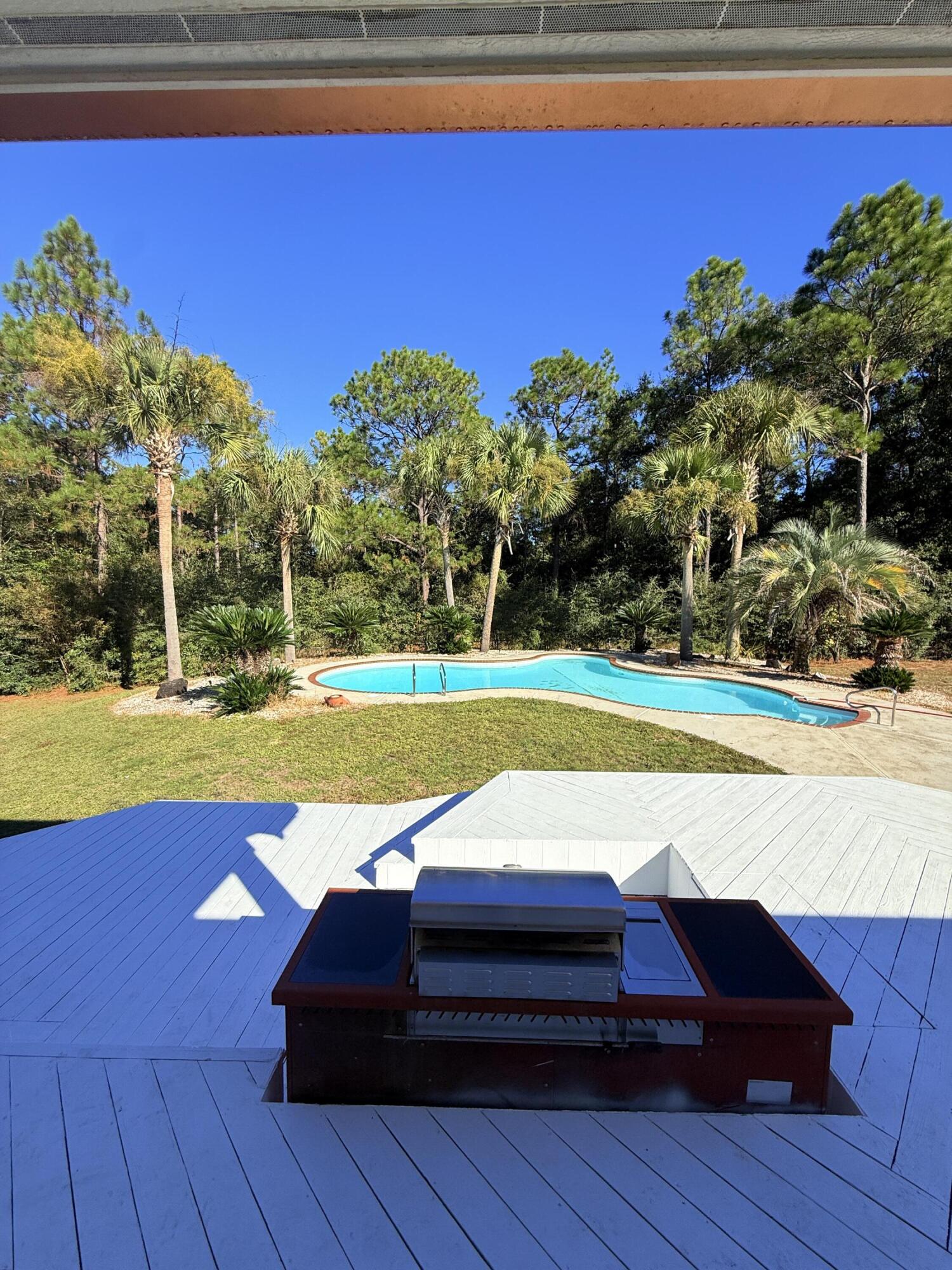 255 Ridge Lake Road Crestview, FL 32536 - Photo 32 of 39 a view of swimming pool with outdoor seating and yard