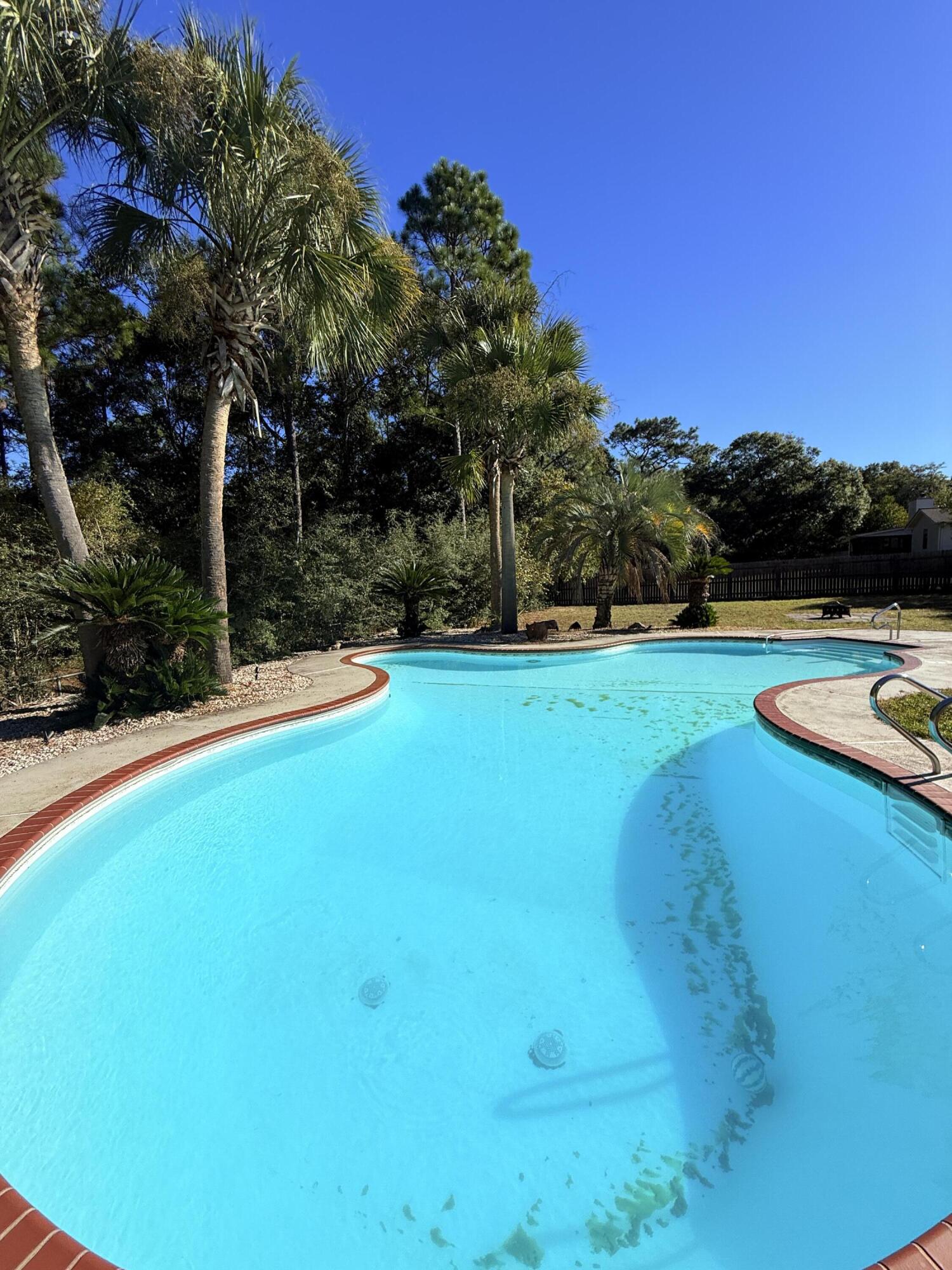 255 Ridge Lake Road Crestview, FL 32536 - Photo 34 of 39 a view of a swimming pool with an outdoor space and seating area