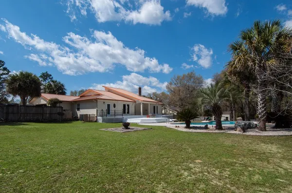 a view of a swimming pool with an outdoor space and seating area