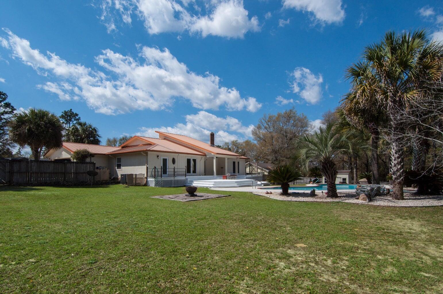 255 Ridge Lake Road Crestview, FL 32536 - Photo 37 of 39 a view of a house with a big yard and large trees