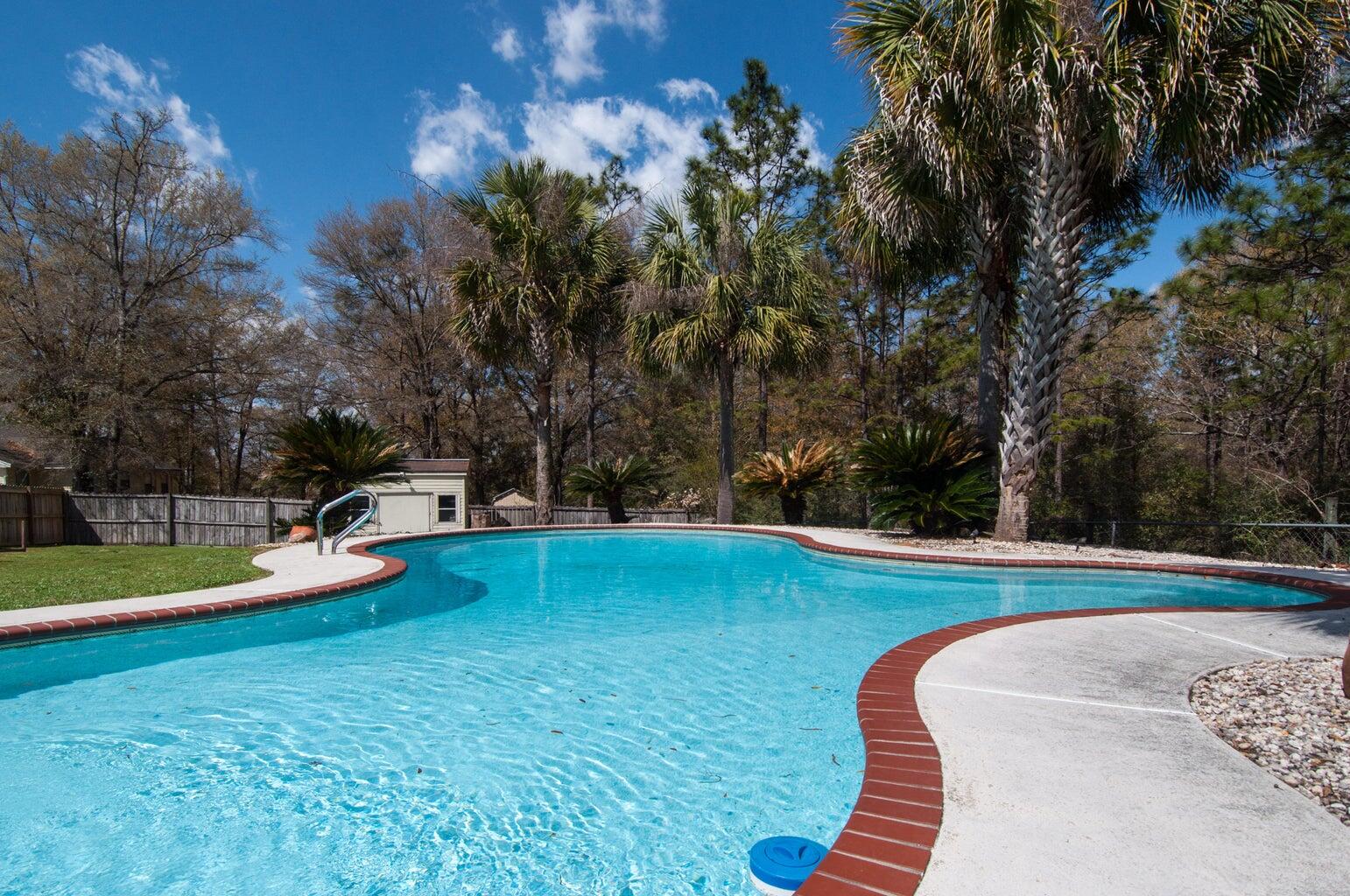 255 Ridge Lake Road Crestview, FL 32536 - Photo 38 of 39 a view of a swimming pool with an outdoor space and seating area