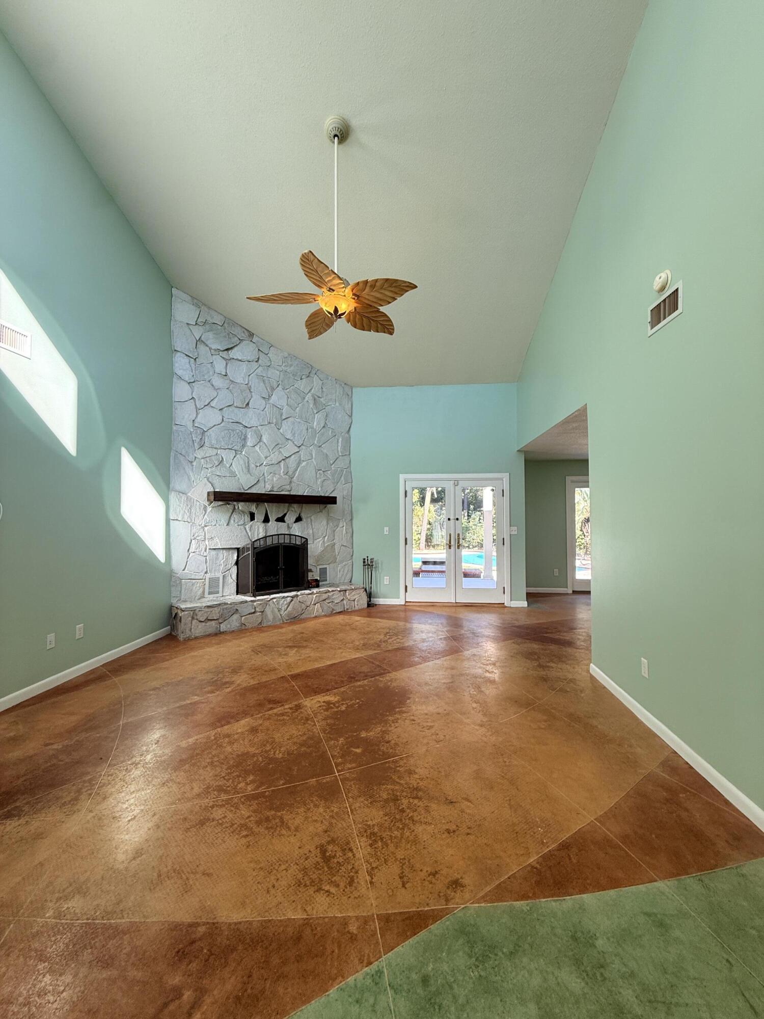 255 Ridge Lake Road Crestview, FL 32536 - Photo 6 of 39 a view of empty room with a fireplace and wooden floor