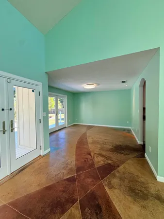 a view of kitchen with stainless steel appliances granite countertop refrigerator stove top oven and sink