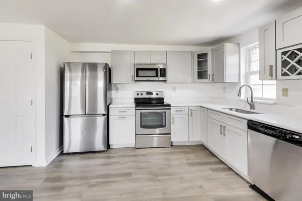 a en suite bathroom with a granite countertop sink and a mirror
