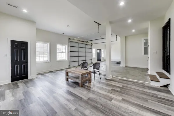 a kitchen with granite countertop white cabinets and stainless steel appliances