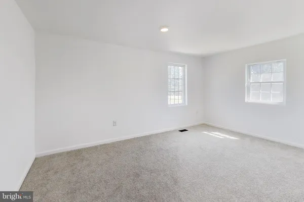 a view of a livingroom with a ceiling fan and window