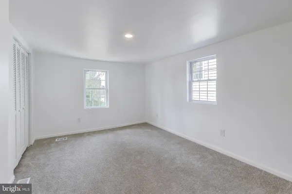 a large bedroom with a large bed and a flat screen tv