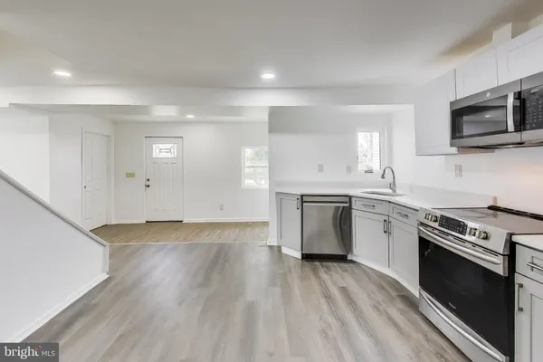 a house that has a big yard with plants and large trees