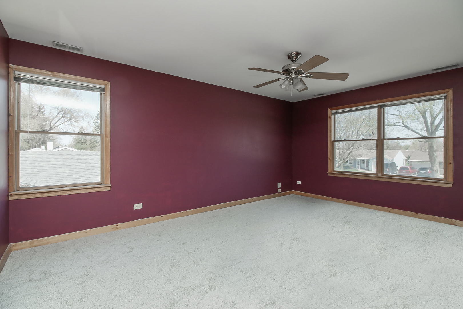 1128 South Wolf Road Des Plaines, IL 60016 - Photo 11 of 20 an empty room with windows and ceiling fan