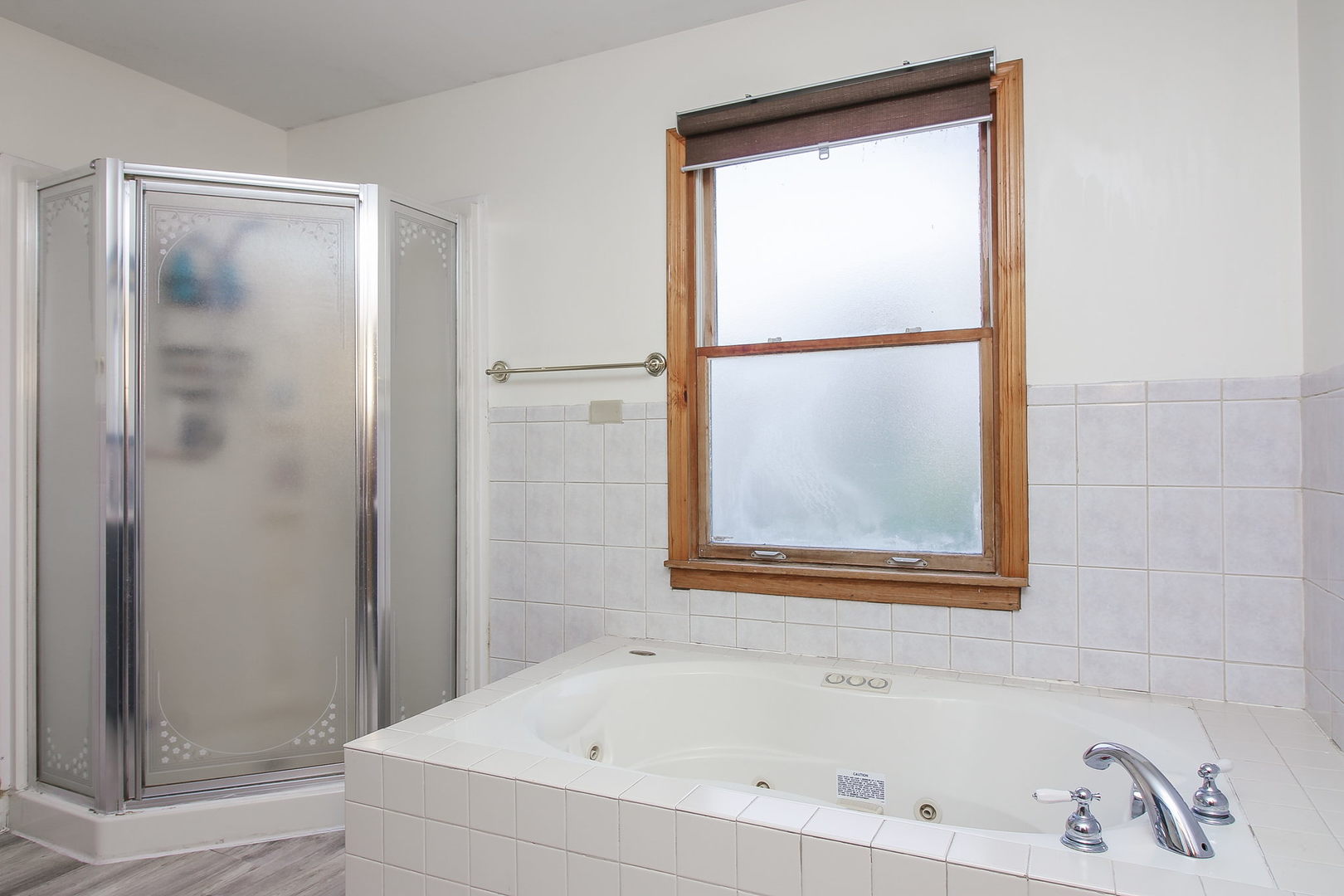 1128 South Wolf Road Des Plaines, IL 60016 - Photo 13 of 20 a white bath tub sitting next to a shower
