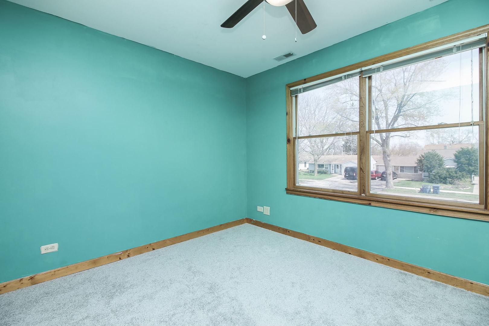 1128 South Wolf Road Des Plaines, IL 60016 - Photo 16 of 20 an empty room with a window and a ceiling fan