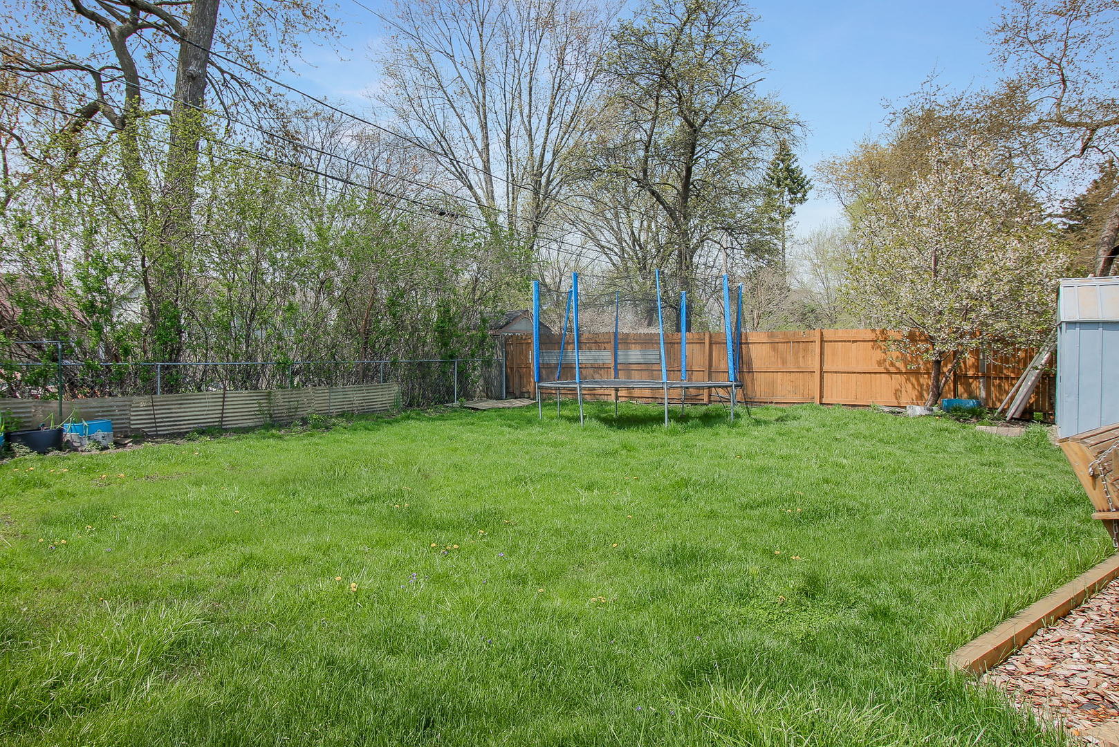 1128 South Wolf Road Des Plaines, IL 60016 - Photo 19 of 20 a view of a yard with a house in the background