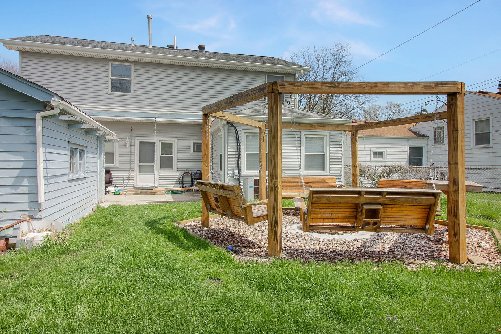 1128 South Wolf Road Des Plaines, IL 60016 - Photo 20 of 20 a view of a house with a backyard and a patio