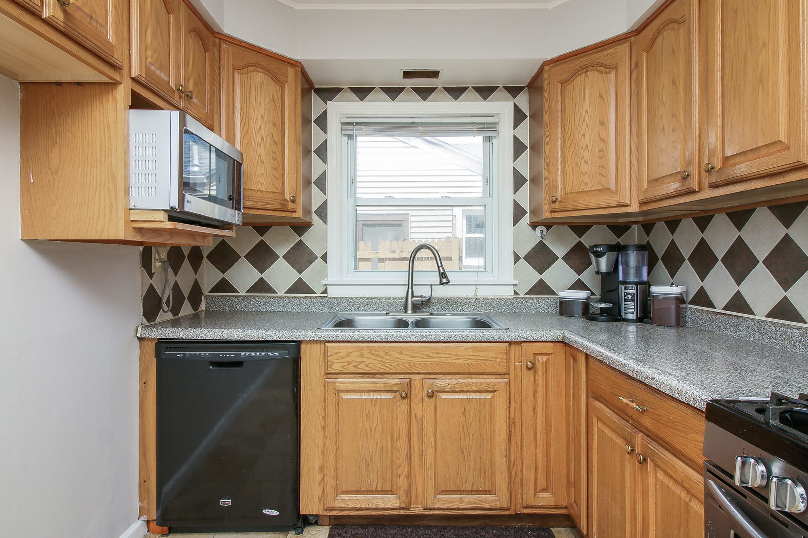 1128 South Wolf Road Des Plaines, IL 60016 - Photo 5 of 20 a kitchen with stainless steel appliances granite countertop a sink and a cabinets