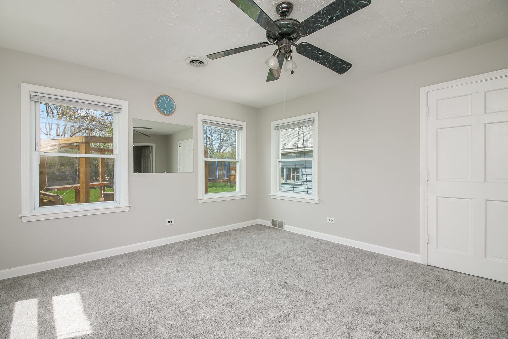 1128 South Wolf Road Des Plaines, IL 60016 - Photo 8 of 20 an empty room with windows and fan
