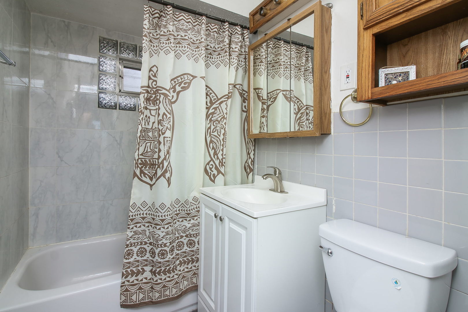 1128 South Wolf Road Des Plaines, IL 60016 - Photo 9 of 20 a bathroom with a sink a toilet and shower curtain