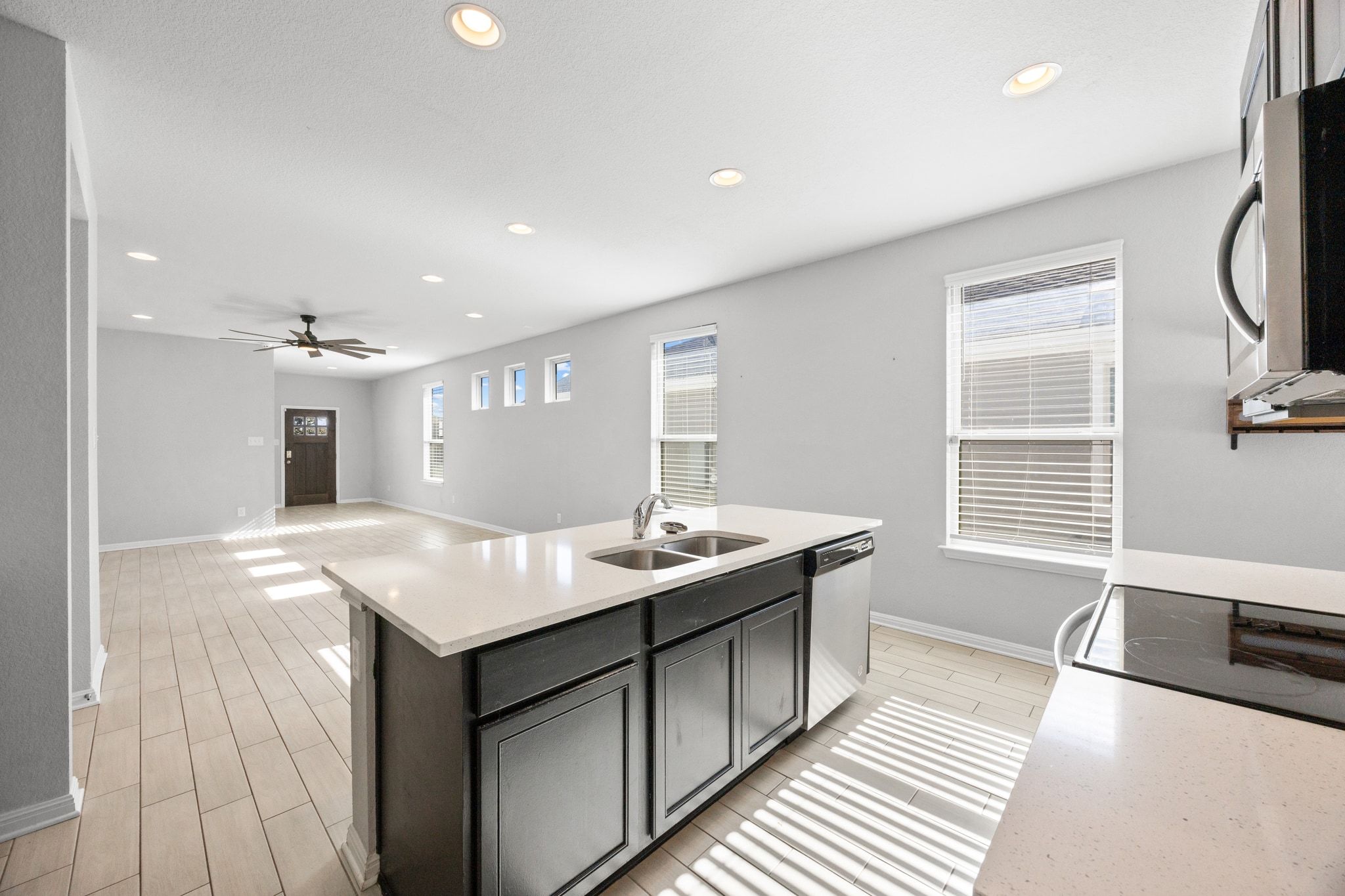 225 Unforgiven Lane Jarrell, TX 76537 - Photo 30 of 30 Kitchen with open floor plan, recessed lighting, stainless steel appliances, a center island with sink, and light stone countertops