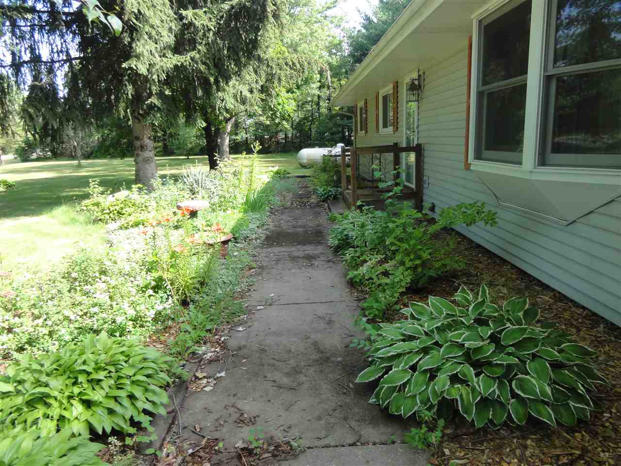 14913 Prairie Road Rockton, IL 61072 - Photo 3 of 19 a view of backyard with table and chairs and potted plants