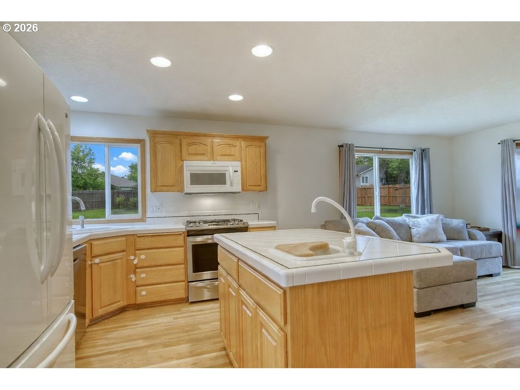 34672 Cascade Street St. Helens, OR 97051 - Photo 11 of 42 a kitchen with a stove a sink a counter space and a refrigerator