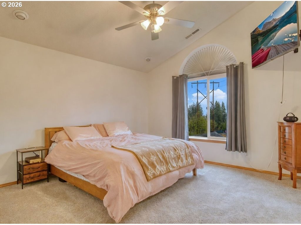 34672 Cascade Street St. Helens, OR 97051 - Photo 18 of 42 a bedroom with a bed and a chandelier
