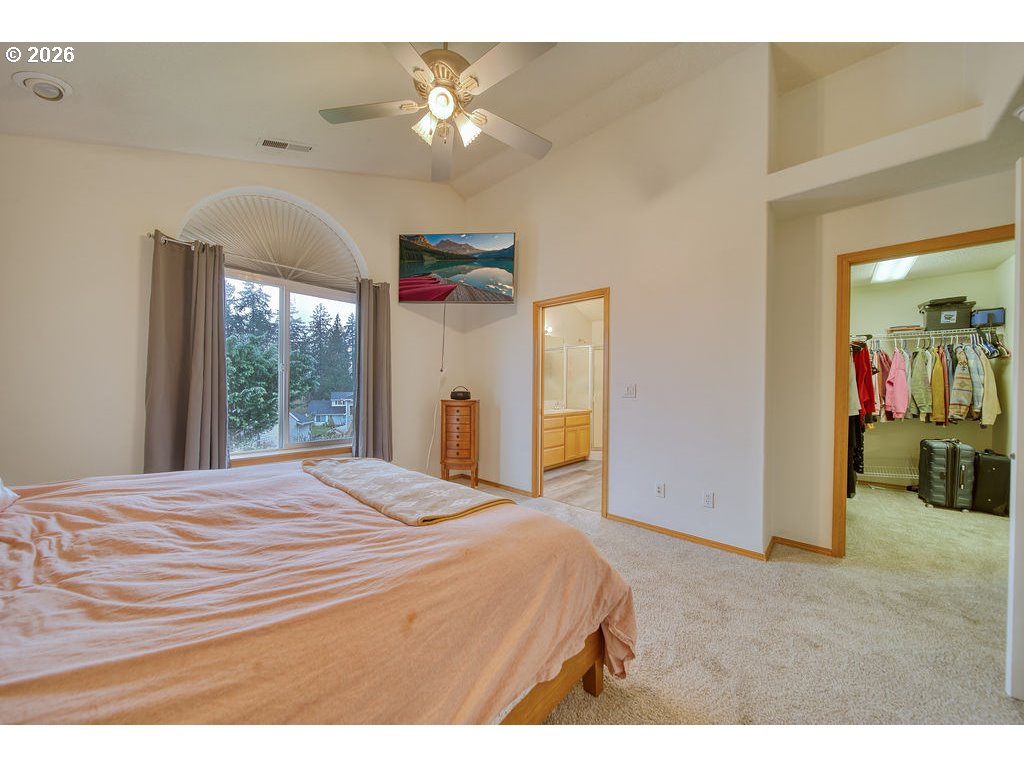 34672 Cascade Street St. Helens, OR 97051 - Photo 19 of 42 a bedroom with a bed and a chandelier