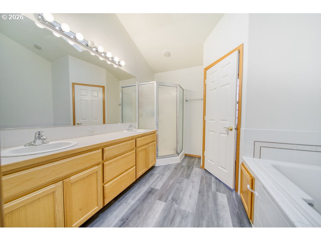 34672 Cascade Street St. Helens, OR 97051 - Photo 22 of 42 a bathroom with a sink a mirror a vanity and a bathtub