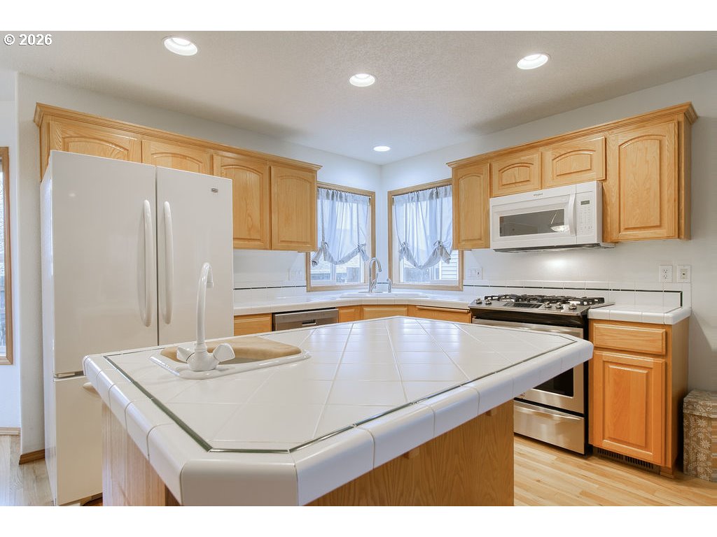 34672 Cascade Street St. Helens, OR 97051 - Photo 10 of 42 a kitchen with a sink a stove and a refrigerator