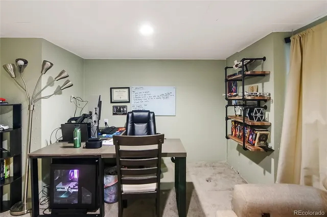 a living room with fireplace furniture and a book shelf