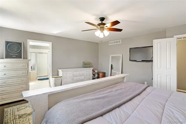 a bedroom with a large bed and a chandelier