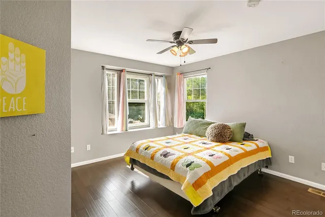 a bedroom with a bed and painting on the wall