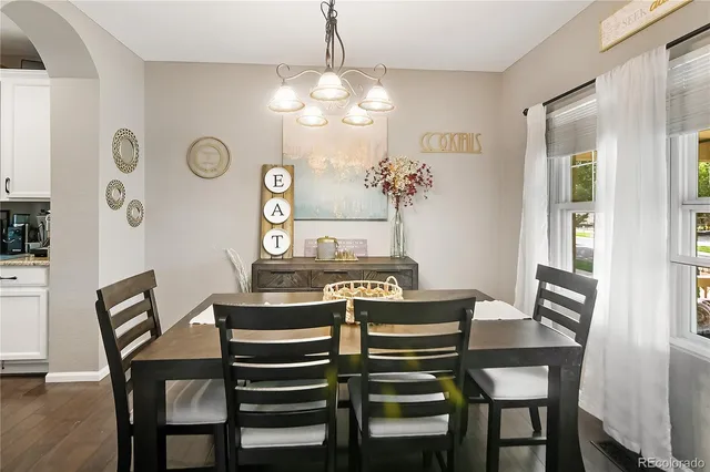 a view of a dining room with furniture and a chandelier