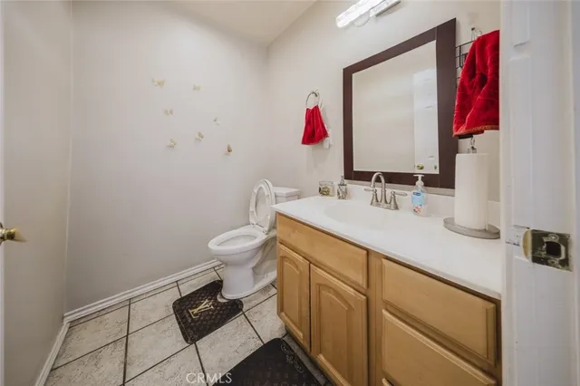 a bathroom with a sink vanity and a toilet