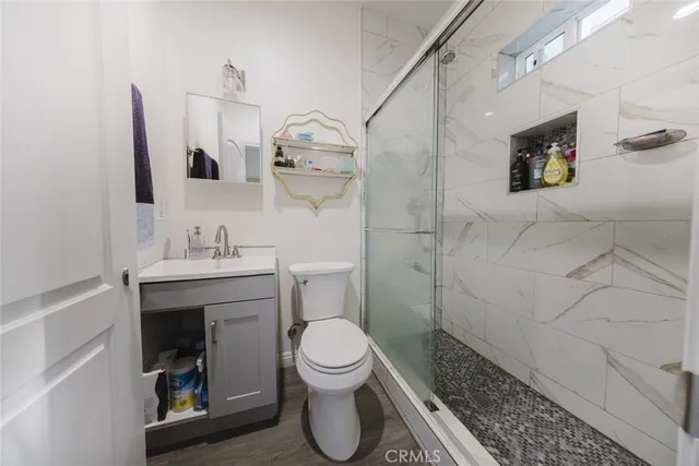 a bathroom with a toilet sink and shower