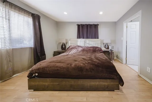 a spacious bedroom with a bed and window