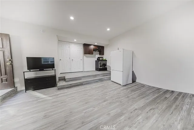 a view of a kitchen with a sink and a refrigerator