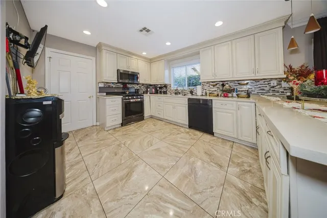 a kitchen with a refrigerator and a stove top oven