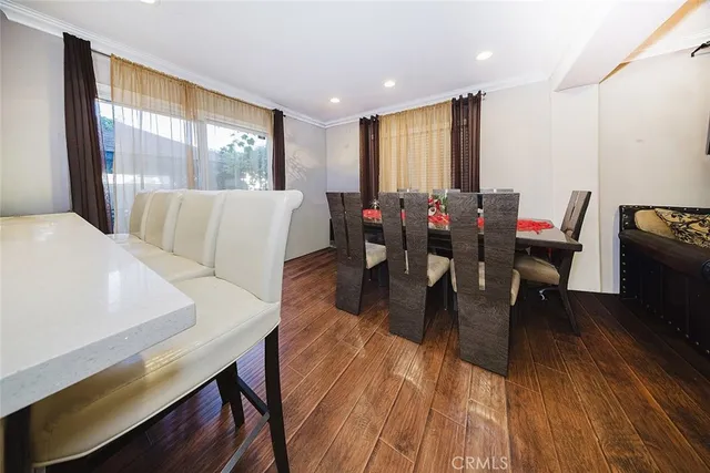 a view of a dining room with furniture and wooden floor