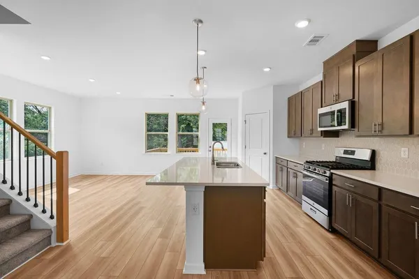 a view of empty room with wooden floor and window