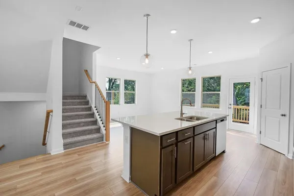 a view of a living room hardwood floor and a ceiling fan