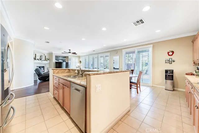 a kitchen with stainless steel appliances granite countertop a refrigerator and a stove top oven