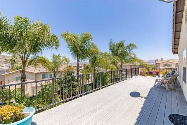 a view of balcony with wooden floor and seating space