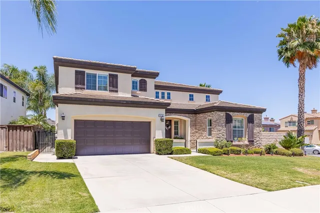 a front view of a house with yard and green space