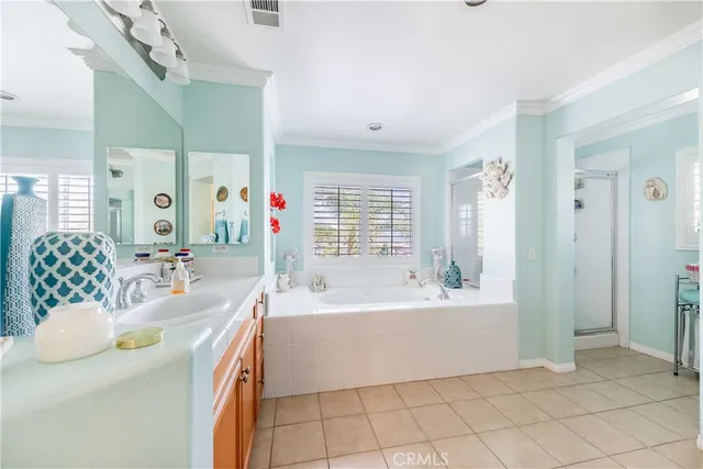 a spacious bathroom with a granite countertop sink mirror and bathtub