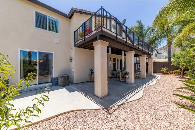 a view of a patio with couches table and chairs and potted plants